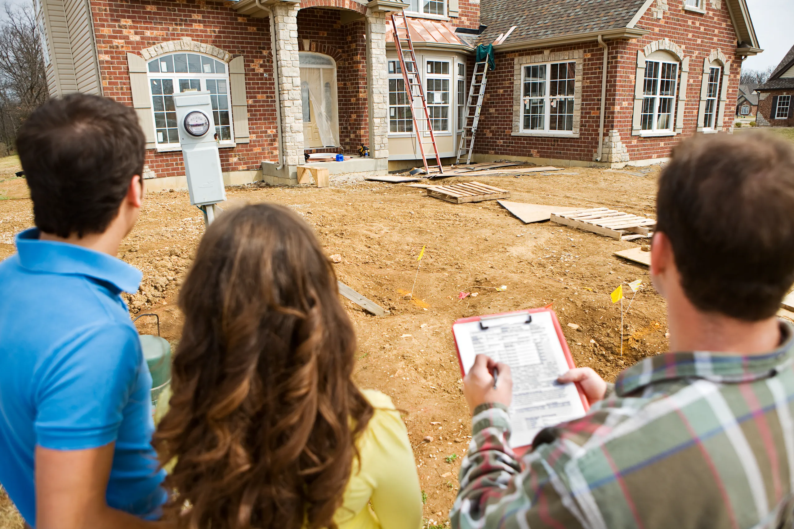 Custom home builder reviewing interior plans
